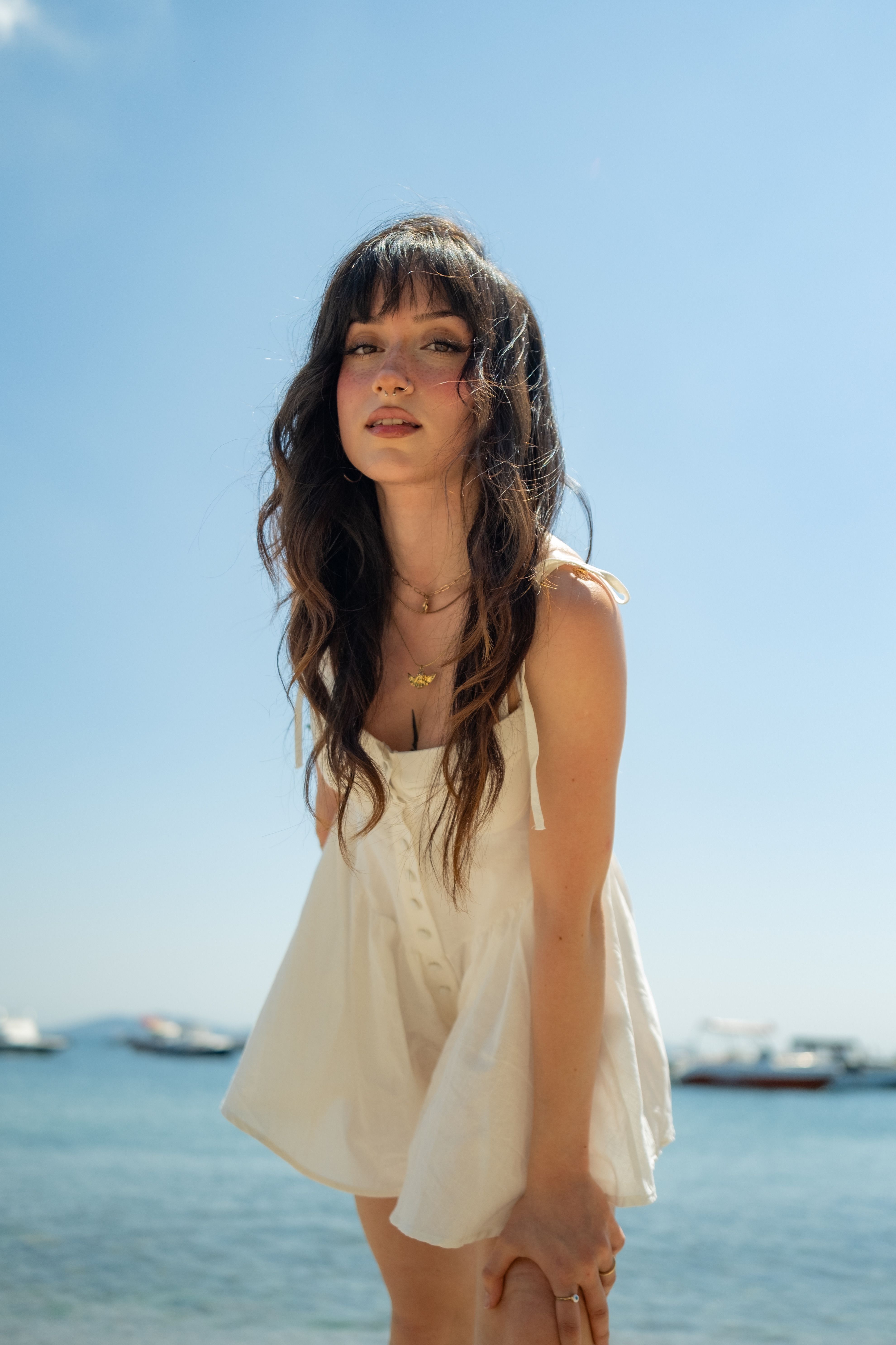 Young Woman in a White Dress Standing on the Shore · Free Stock Photo