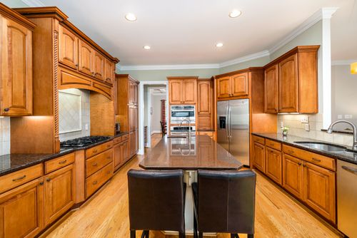 Free Spacious modern kitchen with wooden cabinets and stainless steel appliances. Stock Photo