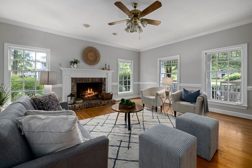 Free Bright living room with fireplace, modern furniture, and natural light. Stock Photo