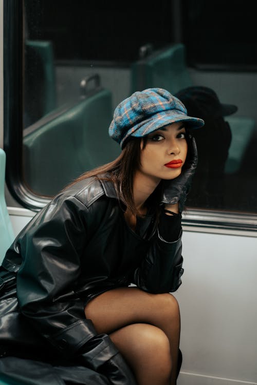 Beautiful Woman in Hat and Leather Coat Sitting in Wagon