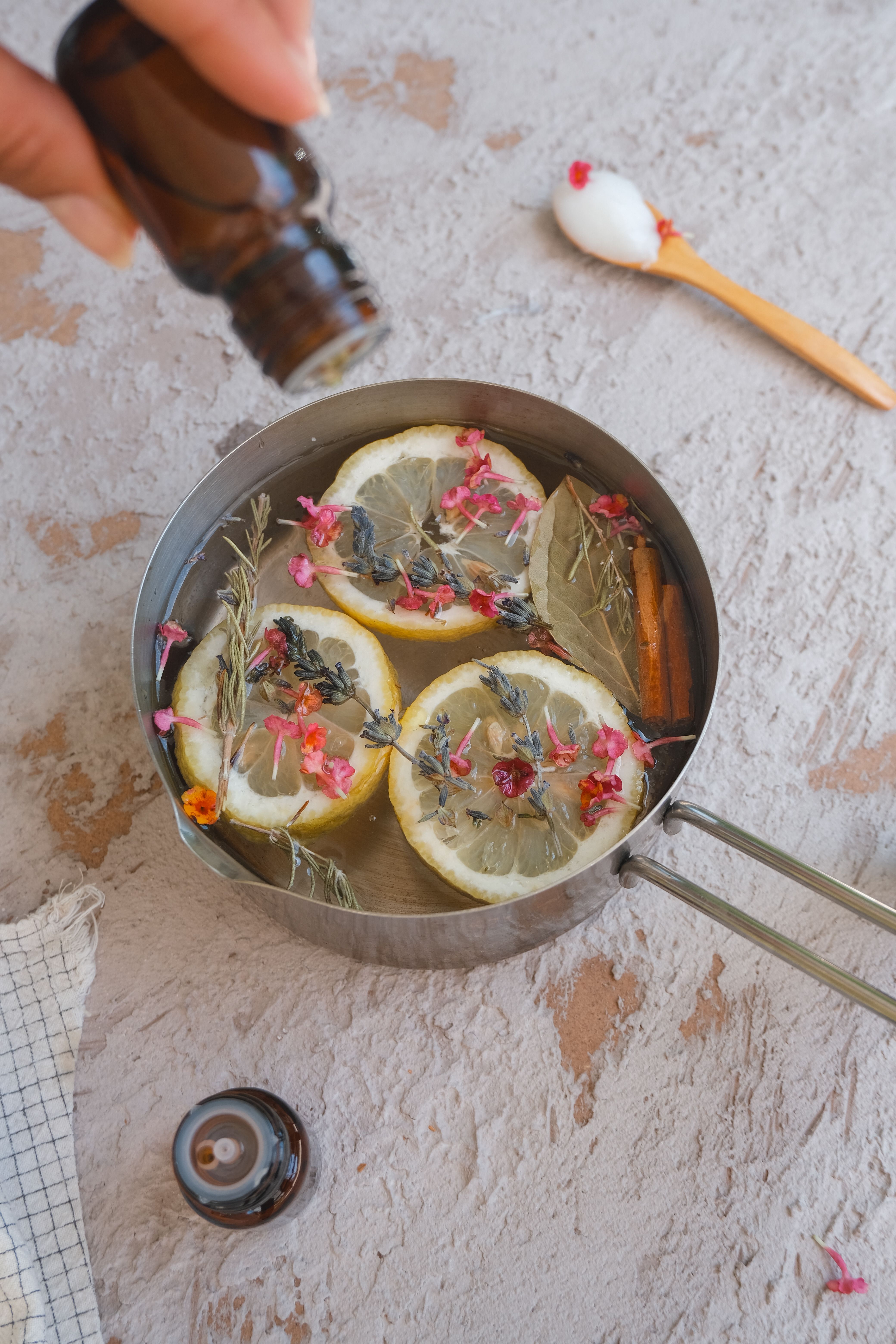 How to make your house smell good naturally: fresh lemons, herbs and a simmer pot on a kitchen stove
