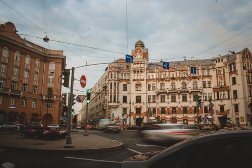 Free A vibrant urban scene featuring historic buildings and fast-paced city traffic. Stock Photo