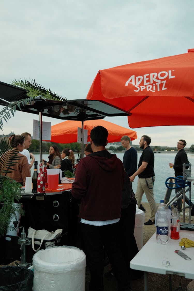 People Standing Near Tables At Food Festival At Boardwalk