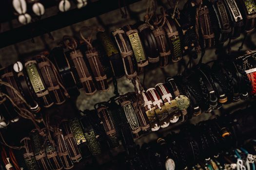A collection of handcrafted leather bracelets displayed artistically on a rack.