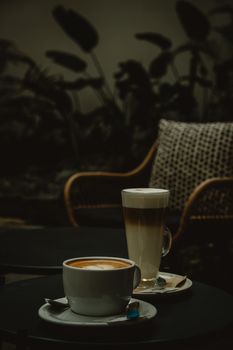 Rustic café ambiance featuring a coffee and latte on a table, creating a warm and inviting atmosphere.