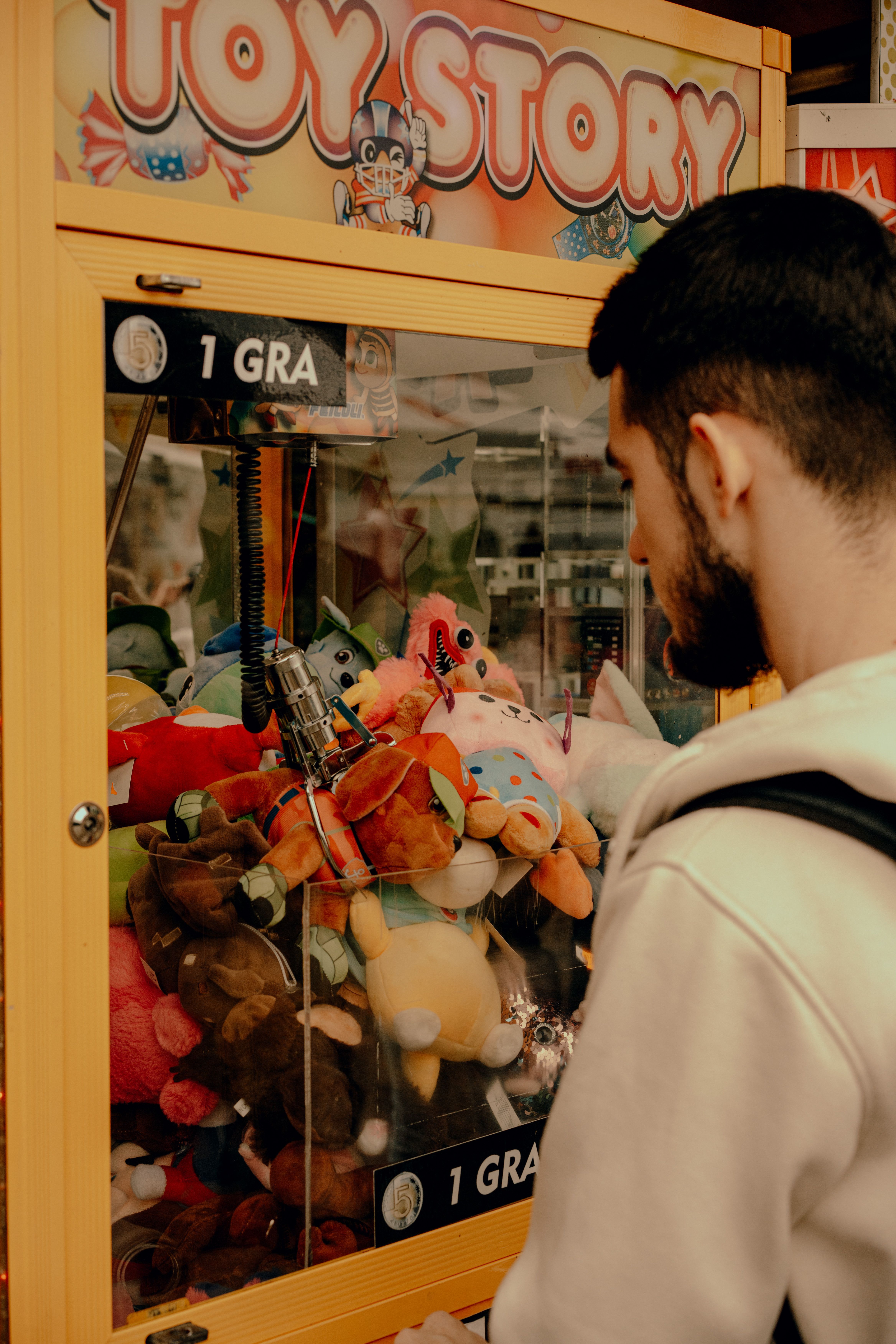 Man in Front of a Toy Machine · Free Stock Photo