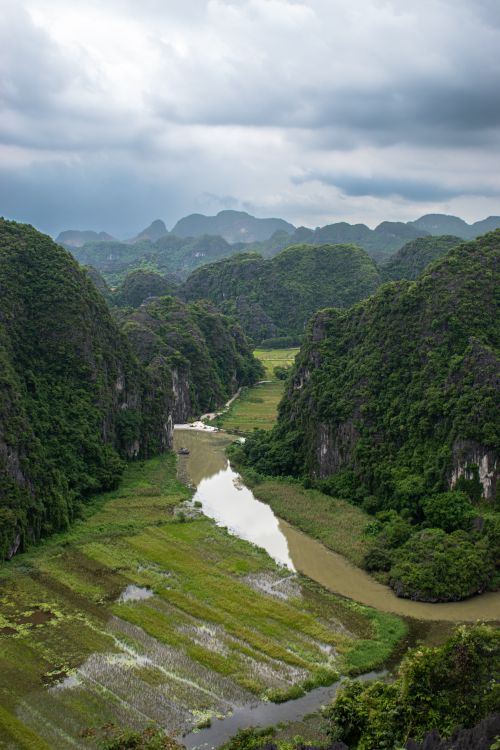 Free Stunning aerial shot of lush green valley and river in Ninh Bình, Vietnam. Stock Photo