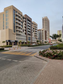 Street view of modern residential buildings and crosswalk in urban area.