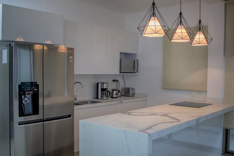 Modern kitchen with white marble and stainless appliances