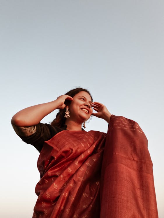 A Woman Wearing a Saree and Smiling 