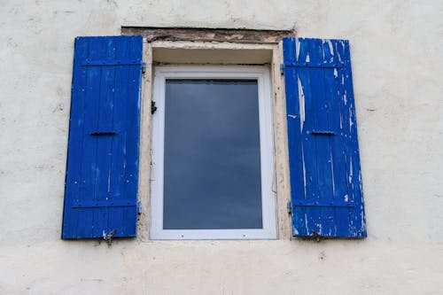 A Window with Wooden Blue Shutters 
