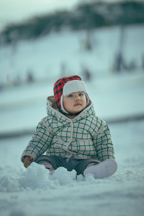 Baby Playing in the Snow on the Slope