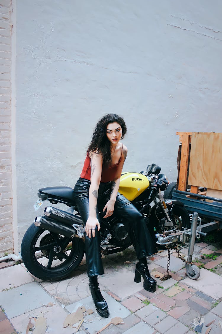 Young Woman Sitting On A Motorcycle 