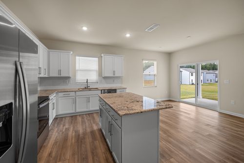 Free A modern kitchen interior featuring sleek appliances, wooden floors, and ample natural light. Stock Photo
