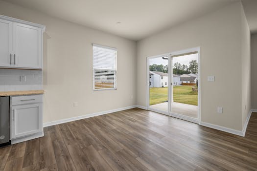 Sunlit modern room with wooden flooring and patio view, ideal for home design inspiration.