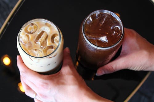 Hands Holding Glasses of Coffee