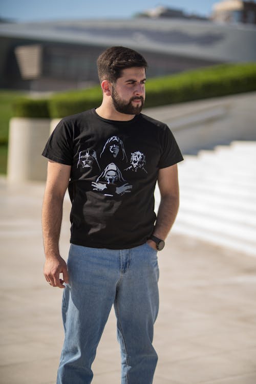 A Bearded Man in a Casual Outfit Standing Outside 