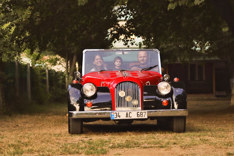 Mother, Father And Child In Vintage Cabriolet