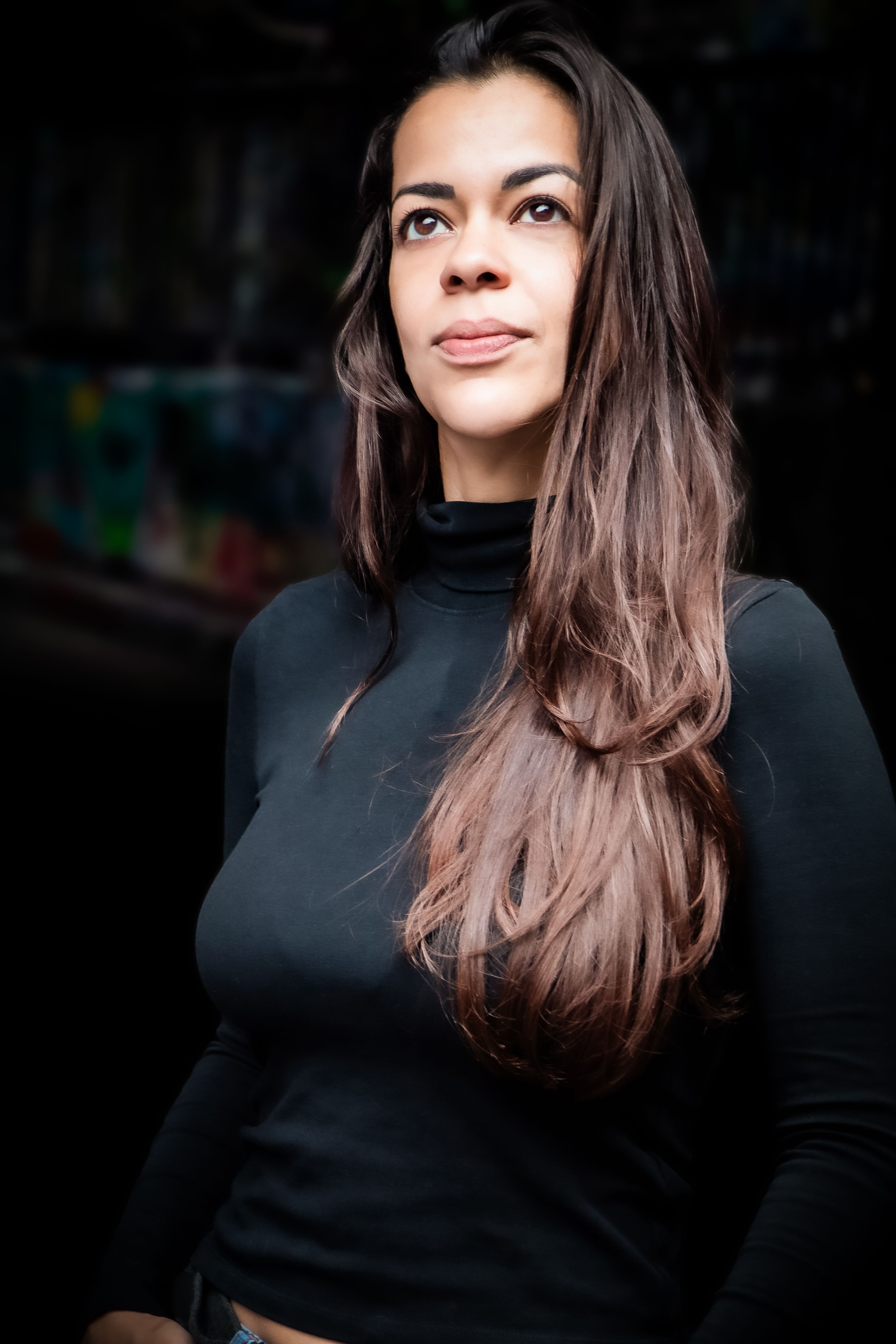 Elegant portrait of a brunette model in black, captured outdoors with an urban background in London.