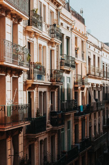 Beautiful residential buildings with balconies in Barcelona, showcasing classic European architecture.