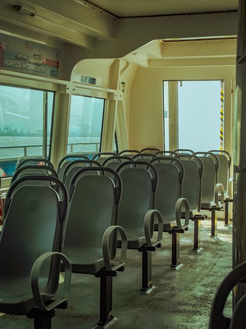 Free Empty ferry interior with neatly arranged rows of seats, highlighting transportation design. Stock Photo