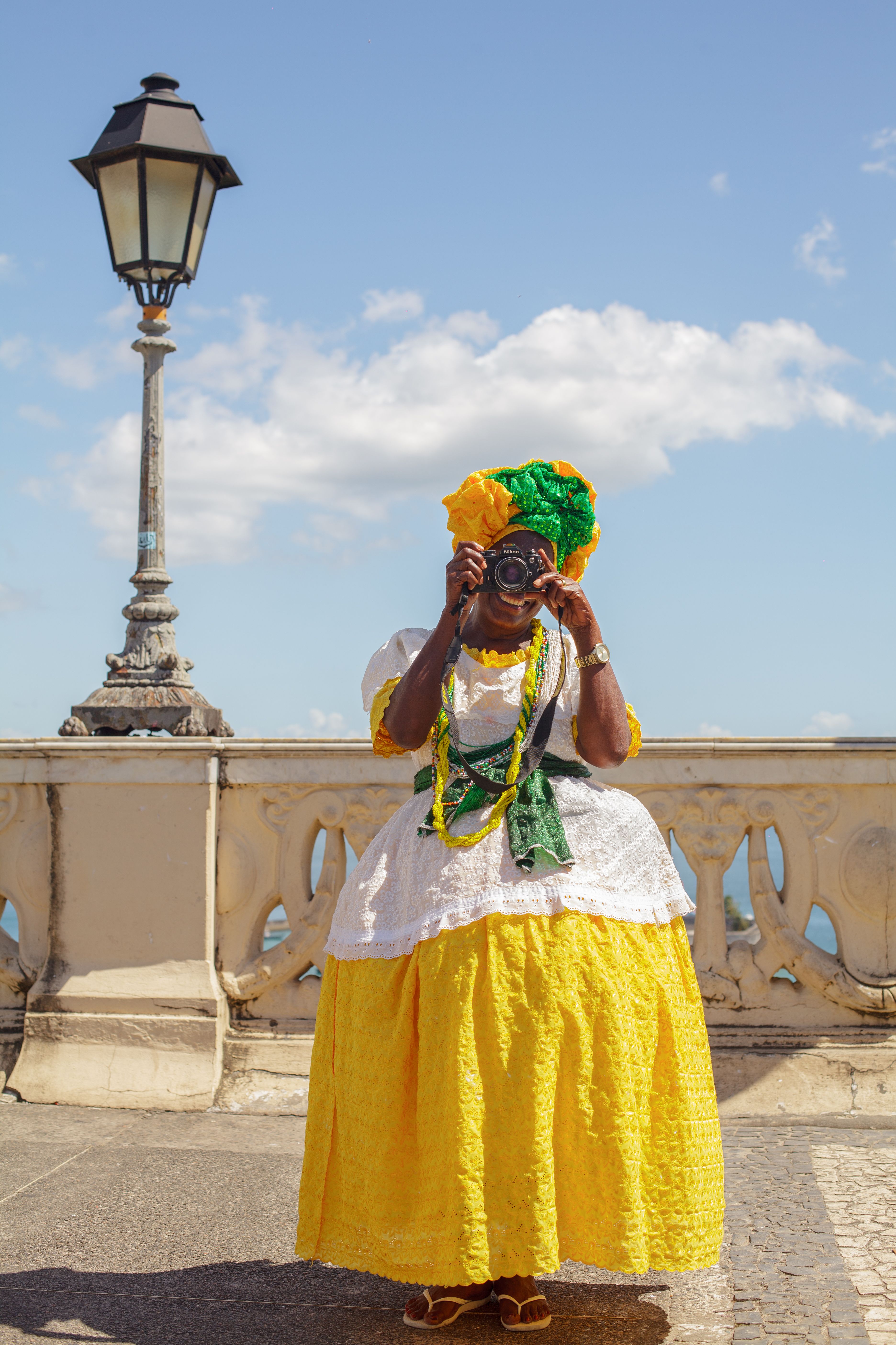 Woman in Traditional Dress Taking Photo  Free Stock Photo