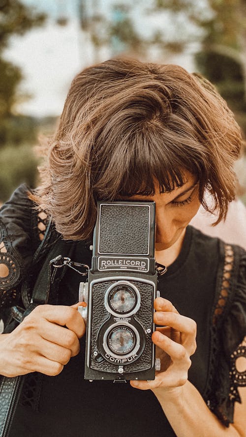 Woman Taking Pictures with Analogue Camera