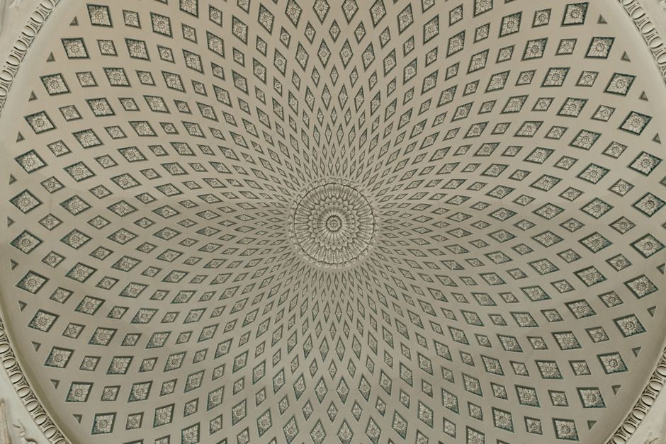 Ornate geometric dome ceiling in Saint Petersburg showcasing intricate design and symmetry.