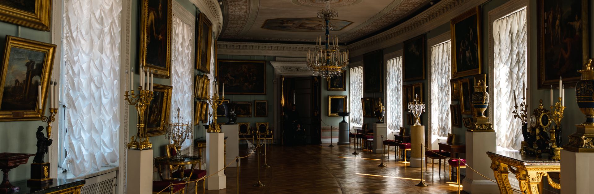 Luxurious art gallery with ornate decor and classic paintings in Saint Petersburg, Russia.