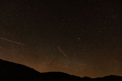 Free A breathtaking view of the starry night sky over hills in Giresun, Türkiye, capturing the beauty of constellations and shooting stars. Stock Photo