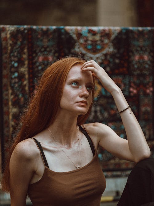 Young Woman Sitting and Looking Up 