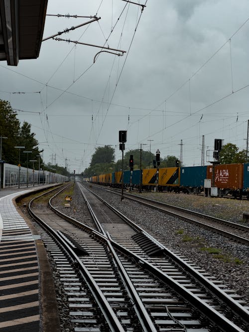 A Cargo Train Passing the Railway Station
