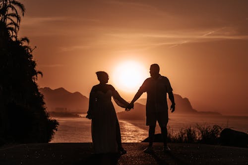 Silhoutte of Couple on Coast at Sunset