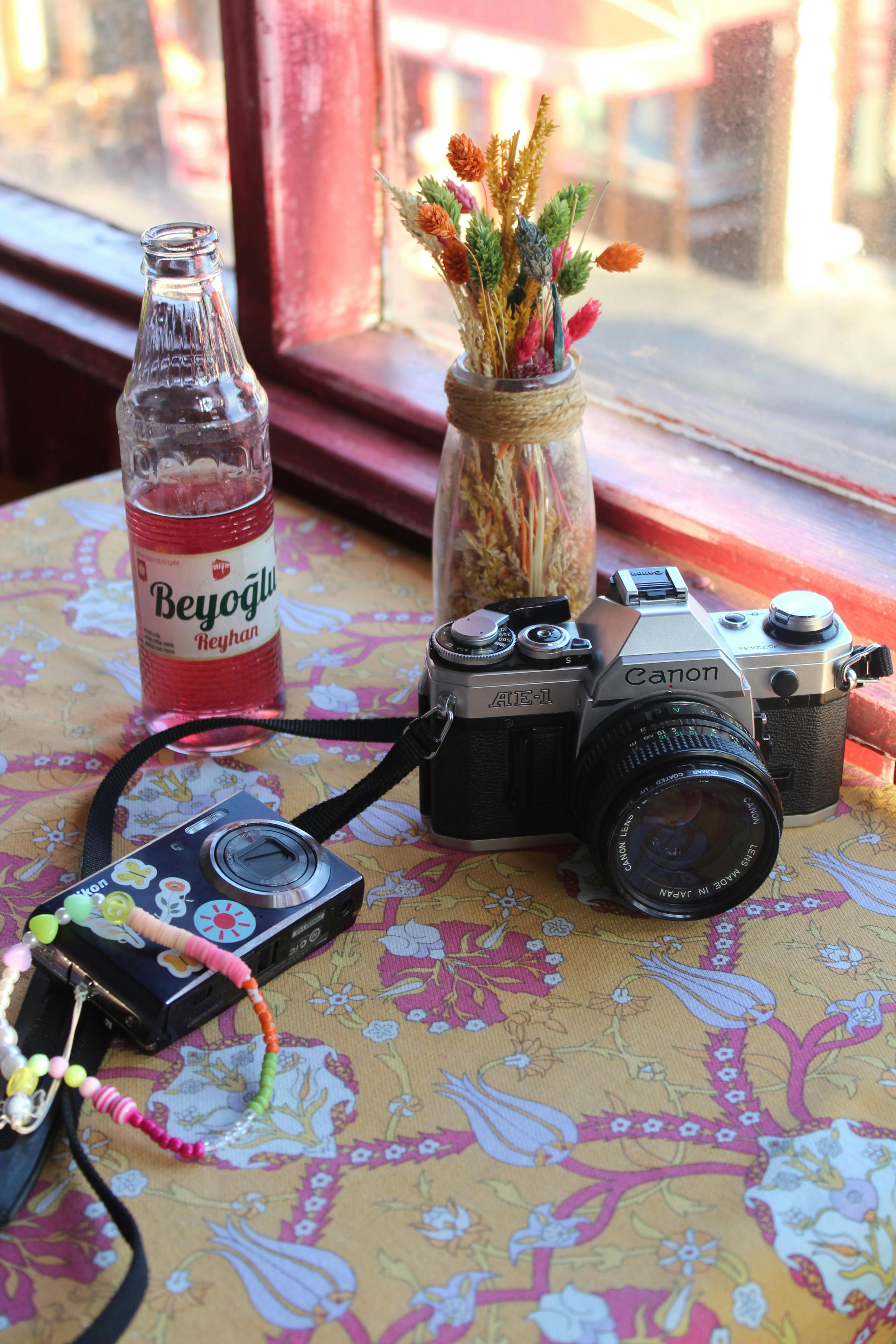 Soda and Cameras on Table in Cafe · Free Stock Photo