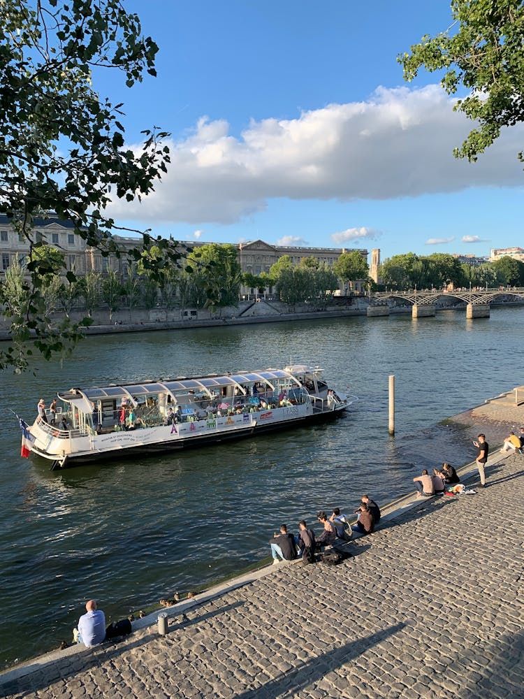 A Bateaux Mouches Boat Taking Tourists For A Tour On The Seine River In Paris, France 