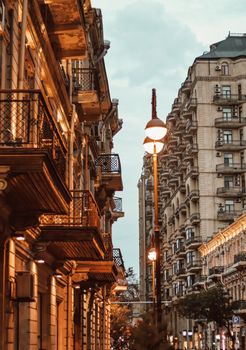 Explore the historic urban charm of Baku with its distinctive architecture under evening street lights.