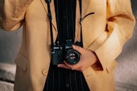 Hand Holding Camera on Leather Strap