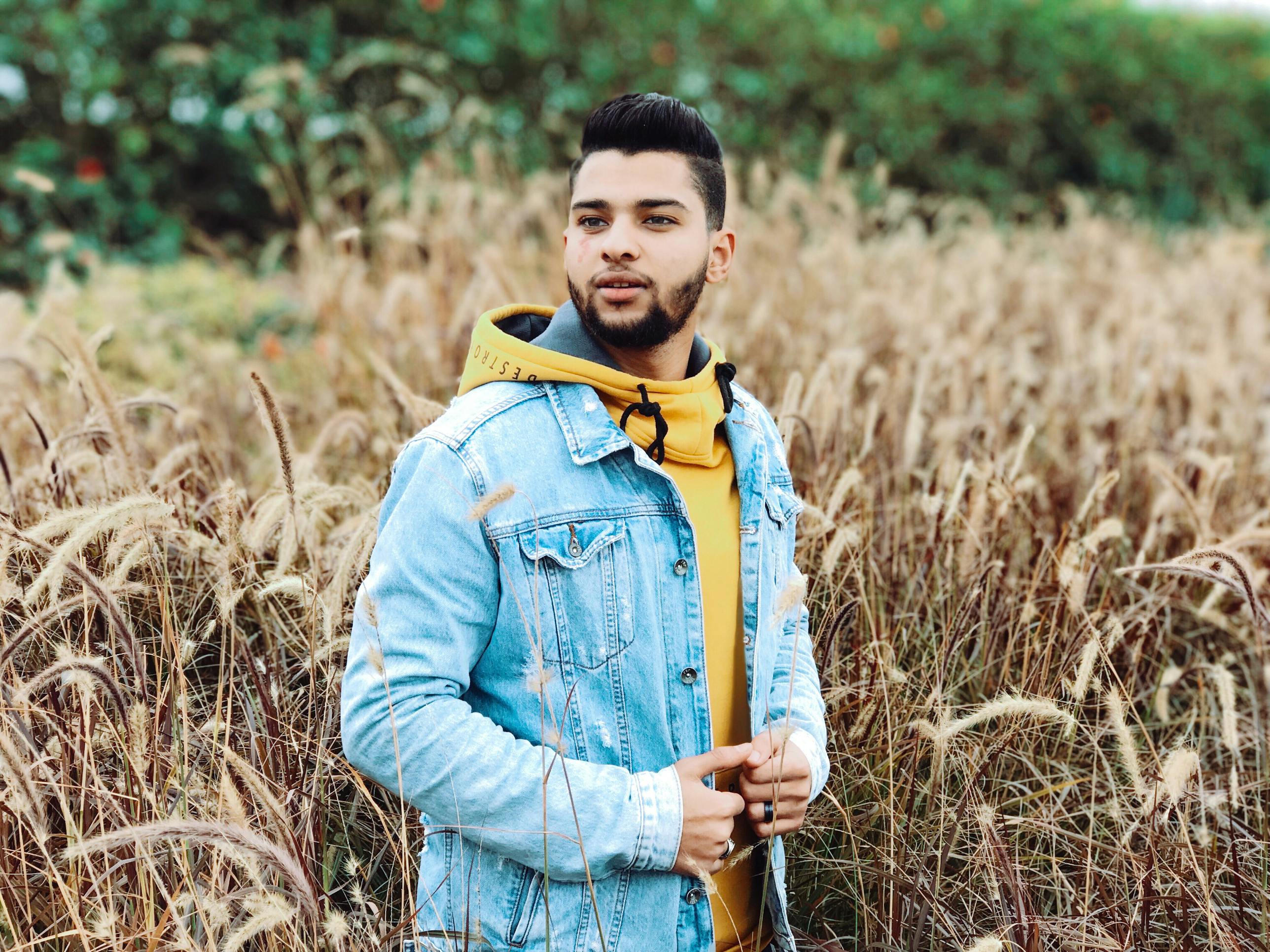 年轻人穿着牛仔夹克，在阳光明媚的田野里享受乡村的一天