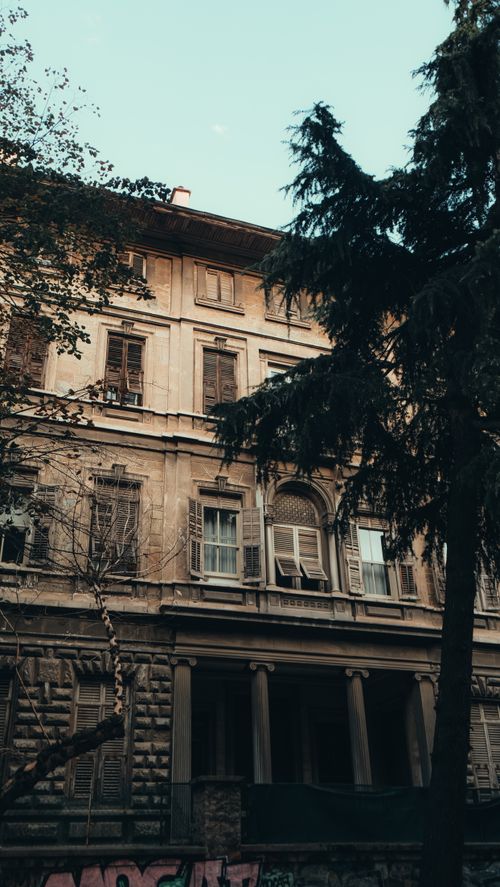 Free Historic building facade with intricate shutters and urban decay. Stock Photo