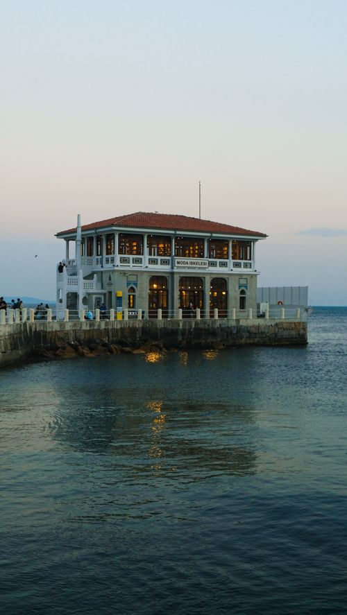 Free Serene view of Moda Pier in Istanbul by the tranquil sea during sunset, capturing the city's beauty. Stock Photo