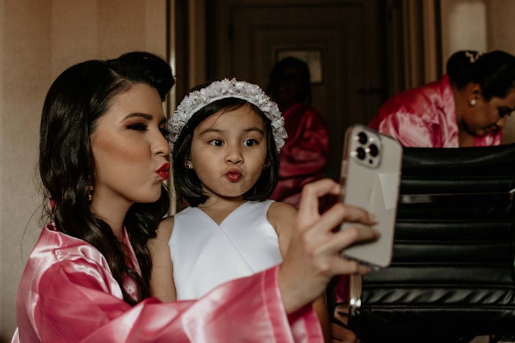 Mother And Daughter Taking Selfie