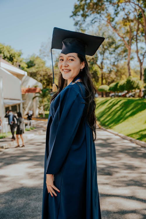 Portrait of a Female University Student Wearing a Mortarboard and a Graduation Gown