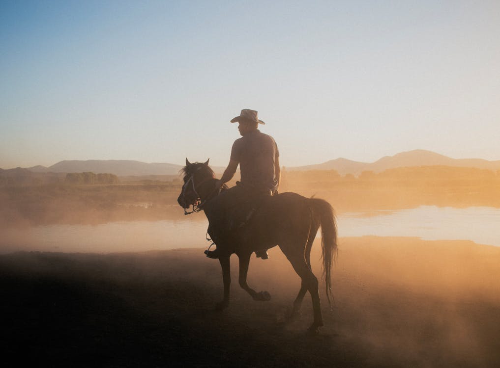Cowboy Riding a Horse at Dawn