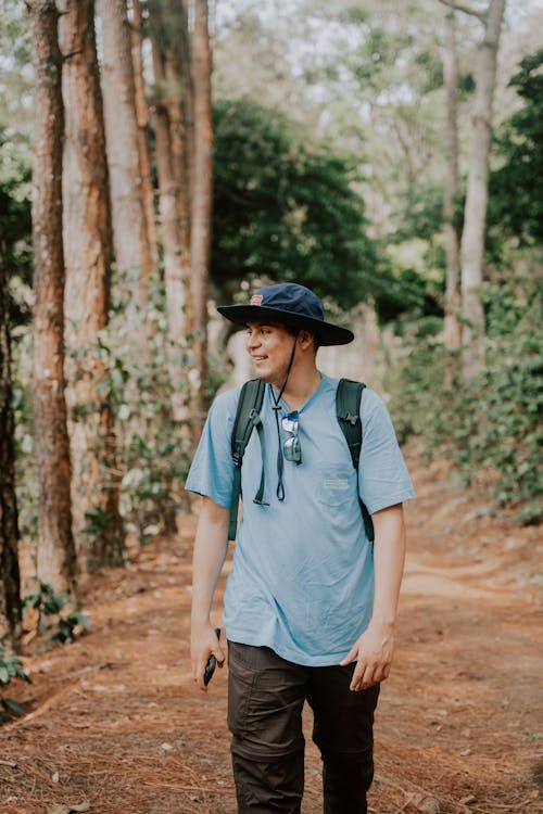 Smiling Man Hiking in Forest