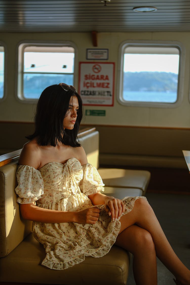 Woman In Sundress Sitting On Ferry