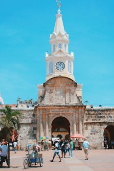 View of the iconic Clock Tower in Cartagena's old town, a vibrant tourist destination.