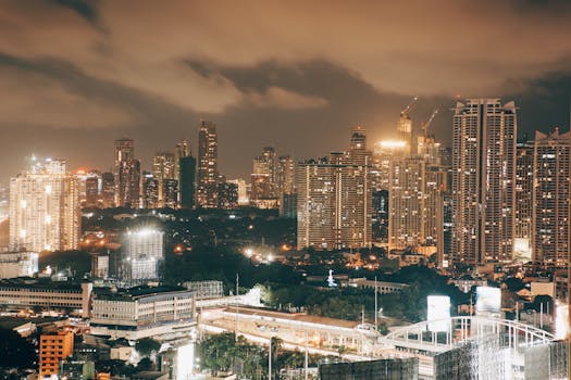 Illuminated cityscape at dusk showcasing modern skyscrapers and dynamic urban landscape.