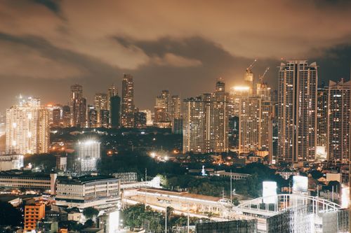 Free Illuminated cityscape at dusk showcasing modern skyscrapers and dynamic urban landscape. Stock Photo