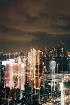 Dynamic cityscape with blurred light trails, showcasing modern skyscrapers at night.