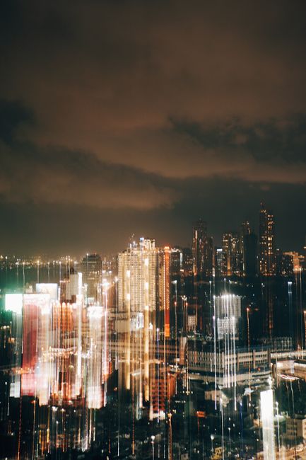 Blurred city lights create a dynamic and vibrant urban skyline at night.
